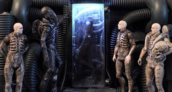 engineers standing in front of a frozen xenomorph